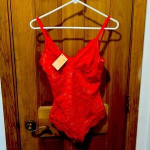 Red lace body suit perfect for wearing under a blazer